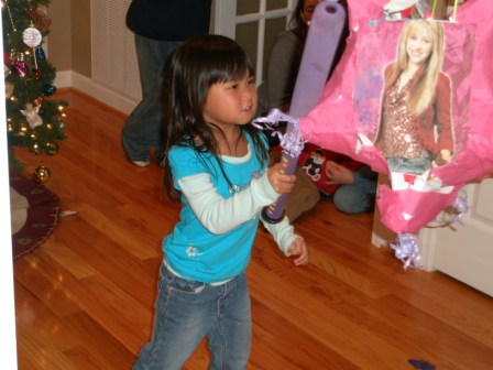 Kasen trying her luck with the pinata